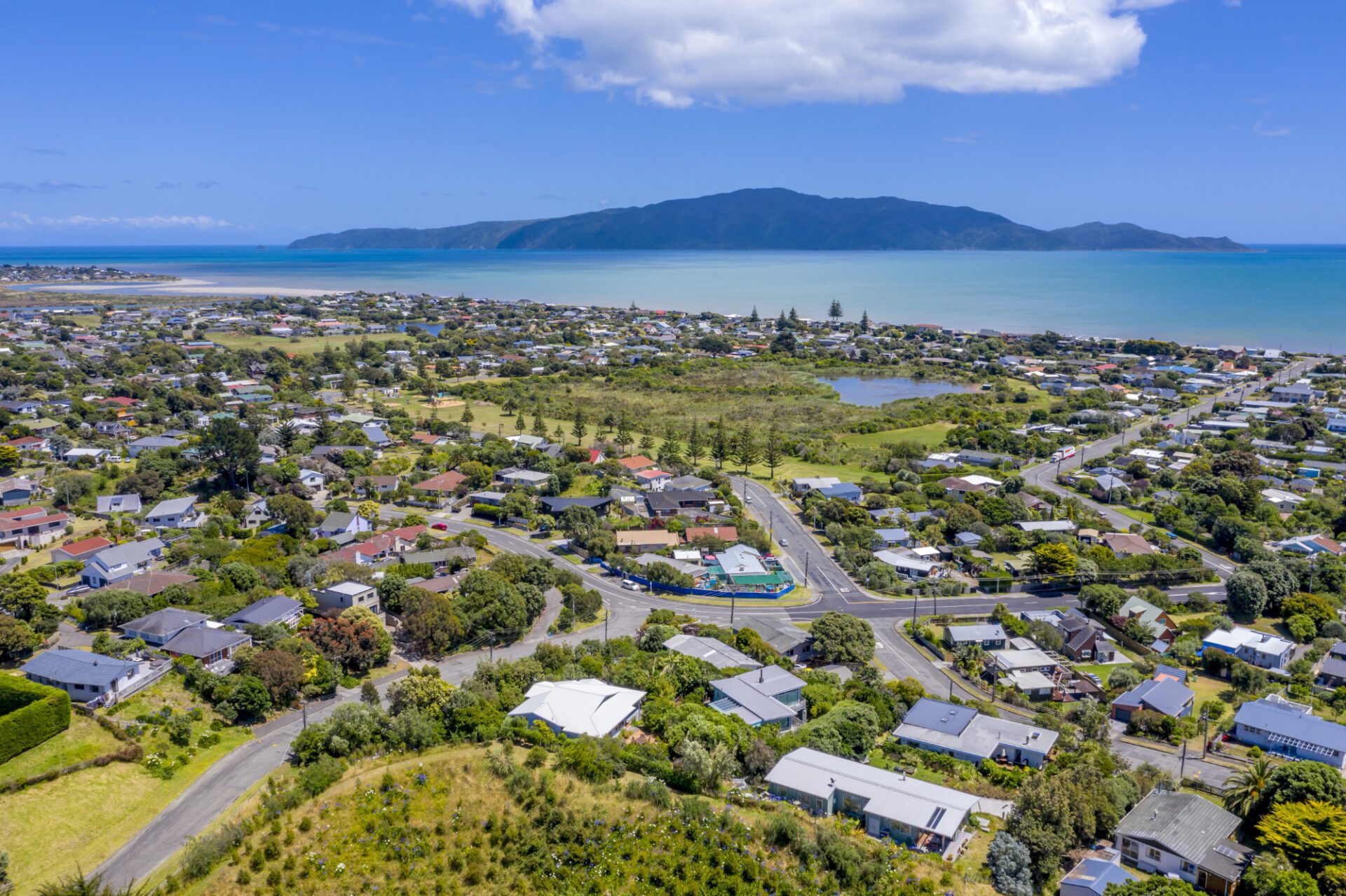 Panoramic shot of a coastal town under blue skies Panoramic shot of a coastal town under blue skies