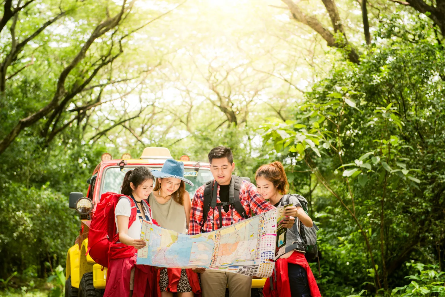 Couple or friends navigating together smiling happy during camping travel hike outdoors in forest Couple or friends navigating together smiling happy during camping travel hike outdoors in forest