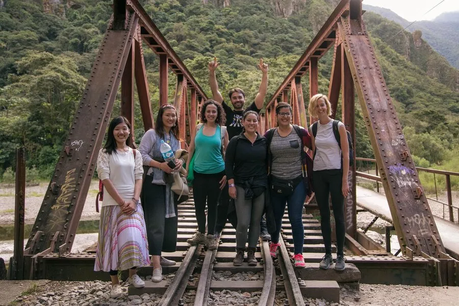 Tourists walking along the railway line towards Machupicchu from the hydroelectric plant Tourists walking along the railway line towards Machupicchu from the hydroelectric plant